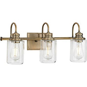Progress P300322-163 Aiken Collection Three-Light Clear Glass Vintage Style Brass Farmhouse Style Bath Vanity Wall Light Alternate Image.jpg