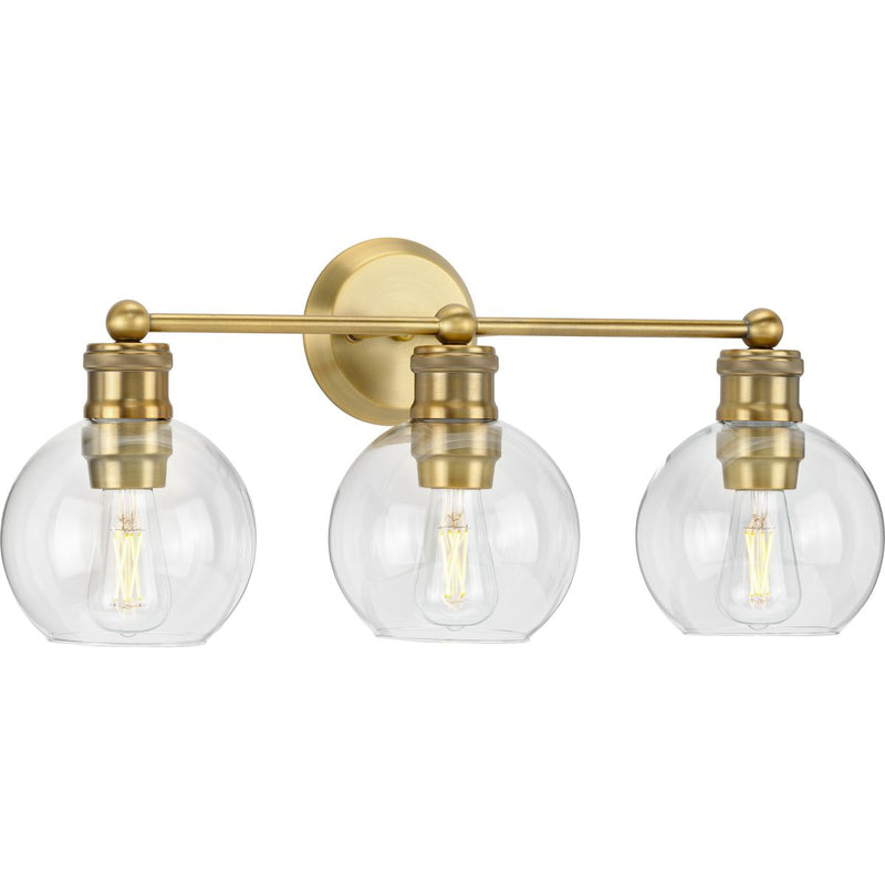 Progress P300051-163 Hansford Collection Three-Light Vintage Brass Clear Glass Farmhouse Bath Vanity Light Main Image.jpg