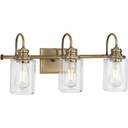 Progress P300322-163 Aiken Collection Three-Light Clear Glass Vintage Style Brass Farmhouse Style Bath Vanity Wall Light Main Image.jpg
