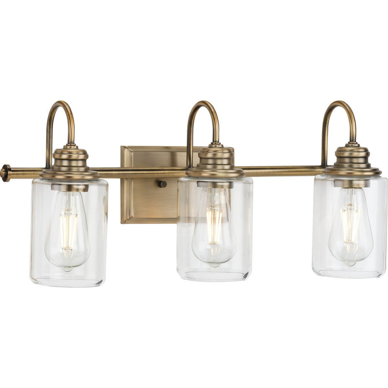 Progress P300322-163 Aiken Collection Three-Light Clear Glass Vintage Style Brass Farmhouse Style Bath Vanity Wall Light Main Image.jpg